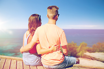 Image showing happy teenage couple sitting on river berth