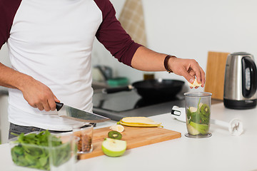 Image showing man with blender and fruit cooking at home kitchen