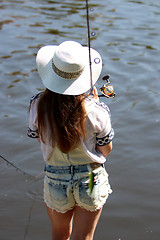 Image showing Young woman with summer sprouts and dungarees