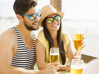 Image showing Friends drinking a cold beer