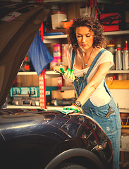 Image showing woman and car in the garage