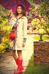 Image showing woman dressed up in a raincoat with an umbrella