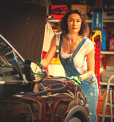 Image showing woman auto mechanic in blue overalls