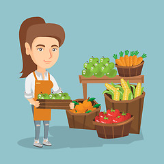 Image showing Caucasian greengrocer holding box with apples.