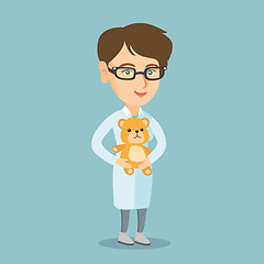 Image showing Caucasian pediatrician doctor holding a teddy bear