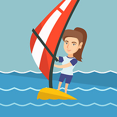 Image showing Young caucasian woman windsurfing in the sea.