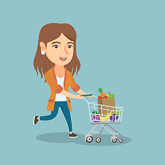 Image showing Caucasian woman running with a shopping trolley.