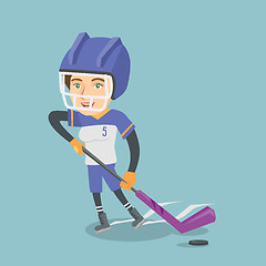 Image showing Young caucasian ice hockey player with a stick.