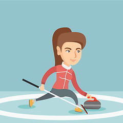 Image showing Sportswoman playing curling on a skating rink.