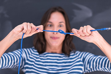 Image showing woman holding a internet cable in front of chalk drawing board