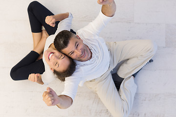 Image showing couple sitting with back to each other on floor