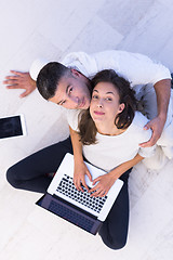 Image showing couple using tablet and laptop computers top view