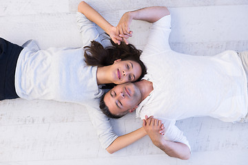Image showing handsome couple lying on floor