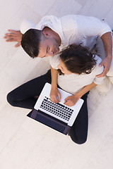 Image showing couple using tablet and laptop computers top view