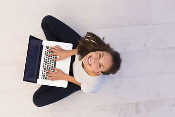 Image showing women using laptop computer on the floor top view