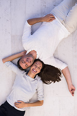 Image showing handsome couple lying on floor