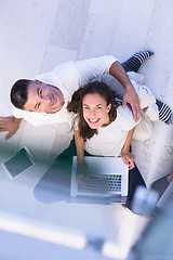 Image showing couple using tablet and laptop computers top view