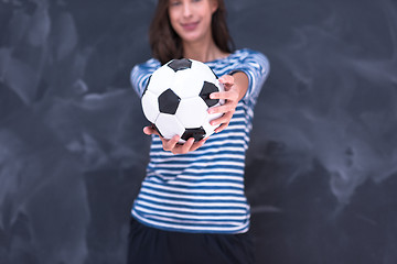 Image showing woman holding a soccer ball in front of chalk drawing board