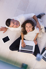 Image showing couple using tablet and laptop computers top view