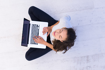 Image showing women using laptop computer on the floor top view