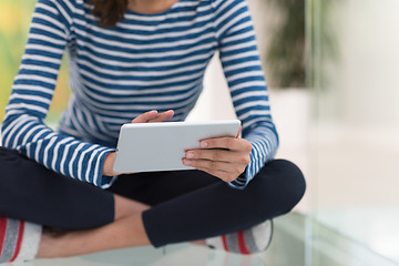 Image showing young women using tablet computer on the floor