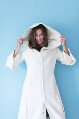 Image showing woman in a white coat with hood isolated on blue background