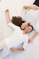 Image showing handsome couple lying on floor