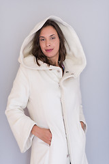 Image showing woman in a white coat with hood isolated on white background