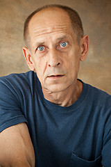 Image showing Worried mature man sitting at studio