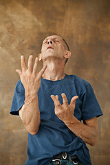 Image showing Worried mature man standing at studio