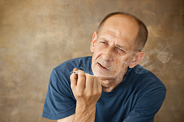Image showing Worried mature man sitting at studio