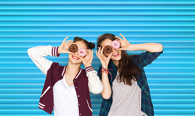 Image showing happy pretty teenage girls with donuts having fun