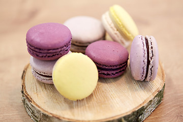 Image showing different macarons on wooden stand