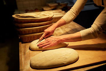 Image showing chef or baker with dough cooking bread at bakery