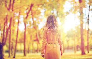 Image showing beautiful young woman walking in autumn park