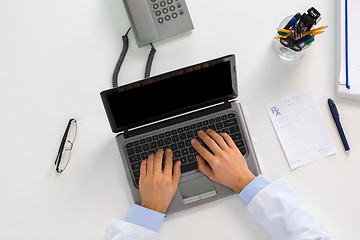 Image showing doctor hands typing on laptop at clinic