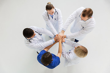 Image showing group of doctors with hands together at hospital