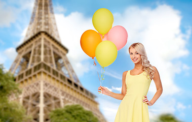 Image showing happy woman in dress with helium air balloons