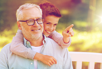 Image showing grandfather and boy pointing finger at summer park