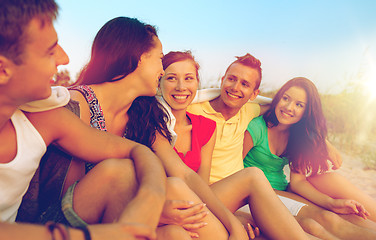 Image showing smiling friends in sunglasses on summer beach