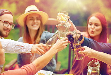 Image showing happy friends with drinks at summer garden party