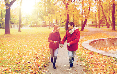 Image showing happy young couple running in autumn park