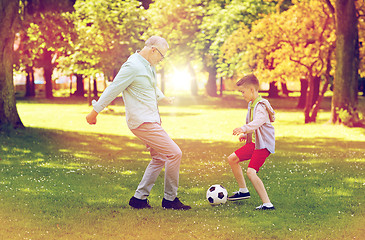 Image showing old man and boy playing football at summer park