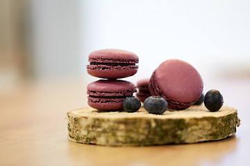 Image showing blueberry macarons on wooden stand