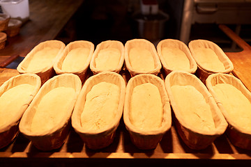 Image showing yeast bread dough in baskets at bakery kitchen