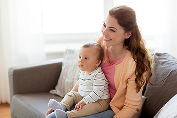 Image showing happy young mother with little baby at home