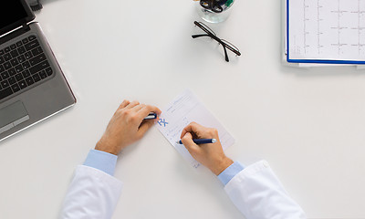 Image showing doctor hands with prescription at clinic