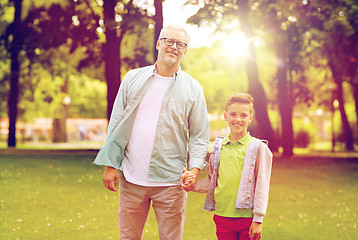 Image showing grandfather and grandson walking at summer park