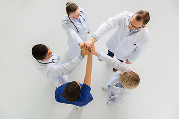 Image showing group of doctors making high five at hospital