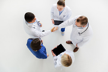 Image showing doctors with tablet pc doing handshake at hospital